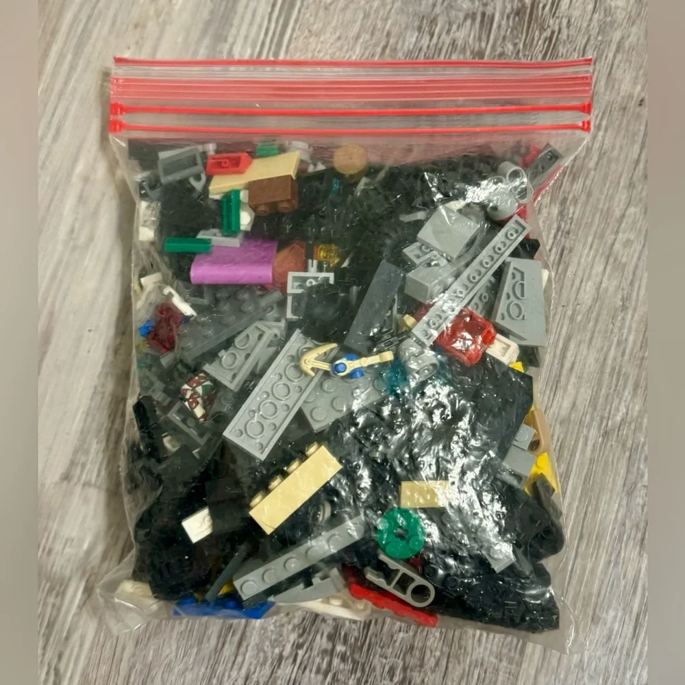 0.697 lbs. Net weight of small Lego bricks. Various parts and pieces. There are